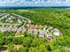 An aerial view of a neighborhood backing to mature trees and green space at 6243 Kilchurn Dr, Indian Land, SC 29707