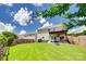 Manicured lawn and fenced yard with outdoor covered patio, fire pit and a bubbling hot tub at 6243 Kilchurn Dr, Indian Land, SC 29707