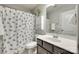 Neutral bathroom featuring a shower-tub combo, decorative cabinet, and modern faucet at 6243 Kilchurn Dr, Indian Land, SC 29707