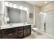 Well-lit bathroom featuring a double sink vanity and a glass-enclosed shower at 6243 Kilchurn Dr, Indian Land, SC 29707