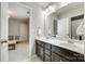 Well-lit bathroom features a double vanity and a view to the bedroom, offering a glimpse of comfortable living at 6243 Kilchurn Dr, Indian Land, SC 29707