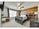 Unique bedroom boasts a wood-paneled accent wall, a comfortable bed, and a decorative Carolina Panthers sign at 6243 Kilchurn Dr, Indian Land, SC 29707