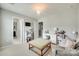 Bright bedroom with a comfy sofa, desk, ottoman, and ample natural light, creating a welcoming and functional space at 6243 Kilchurn Dr, Indian Land, SC 29707