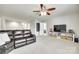 Bright bonus room offers flexible living space with a ceiling fan, television, and view to other parts of the home at 6243 Kilchurn Dr, Indian Land, SC 29707