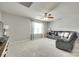 Cozy bonus room features neutral walls, plush carpeting, and a comfortable leather sectional, creating a relaxing living space at 6243 Kilchurn Dr, Indian Land, SC 29707