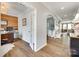 Bright home entryway featuring wood-look floors, a decorative archway, and views into the living room at 6243 Kilchurn Dr, Indian Land, SC 29707