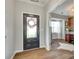 Inviting home foyer with a glass-paneled front door and wood-look flooring at 6243 Kilchurn Dr, Indian Land, SC 29707