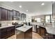 Modern kitchen with stainless steel appliances, a kitchen island, and dark cabinetry at 6243 Kilchurn Dr, Indian Land, SC 29707