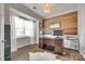 Stylish home office with a wood-paneled accent wall and a large window at 6243 Kilchurn Dr, Indian Land, SC 29707