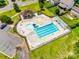 Aerial view of a community pool with ample lounge seating, a splash area, and a nearby clubhouse at 6243 Kilchurn Dr, Indian Land, SC 29707