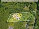 Aerial property lines indicate the expansive land amidst a beautiful wooded area with pool and outbuildings at 6811 Kluttz Rd, Concord, NC 28025