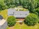 Overhead view of house showing the in-ground swimming pool and verdant landscaping creating a private oasis at 6811 Kluttz Rd, Concord, NC 28025