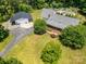 Expansive aerial view of the home, detached garage and lush grounds featuring an in-ground swimming pool at 6811 Kluttz Rd, Concord, NC 28025