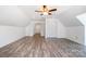 Bright attic featuring wood floors, closet space, and a ceiling fan at 6811 Kluttz Rd, Concord, NC 28025