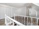 Spacious attic featuring wood floors, white walls, and staircase with white banister at 6811 Kluttz Rd, Concord, NC 28025
