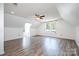 Bright attic space with hardwood floors, windows, and ceiling fan at 6811 Kluttz Rd, Concord, NC 28025