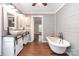 Updated bathroom featuring shiplap walls, dual sinks and a freestanding tub at 6811 Kluttz Rd, Concord, NC 28025