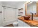 Charming bathroom featuring live-edge wooden countertop, copper sink, and rustic wood shelving for a unique, natural aesthetic at 6811 Kluttz Rd, Concord, NC 28025
