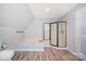 Bright bathroom with wood floors, white walls, soaking tub and walk-in shower at 6811 Kluttz Rd, Concord, NC 28025