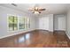 Bedroom featuring hardwood floors, large windows, and double closets at 6811 Kluttz Rd, Concord, NC 28025