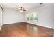 Spacious bedroom with hardwood floors, ceiling fan and large windows at 6811 Kluttz Rd, Concord, NC 28025