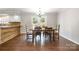 Inviting dining area with a wood table, chandelier, and French doors to the outdoor space at 6811 Kluttz Rd, Concord, NC 28025