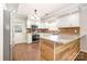 Updated kitchen boasts white cabinets, stainless steel appliances, and granite countertops at 6811 Kluttz Rd, Concord, NC 28025