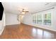 Bright living room with hardwood flooring, a ceiling fan, and large windows offering scenic views at 6811 Kluttz Rd, Concord, NC 28025