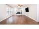 Spacious living room featuring a brick fireplace, hardwood floors, and large windows for ample light at 6811 Kluttz Rd, Concord, NC 28025
