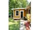 Backyard of the home featuring a covered deck, mature trees, and grassy lawn at 6832 Delta Lake Dr, Charlotte, NC 28215