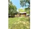 Backyard of the home featuring a deck, mature trees, and a grassy lawn at 6832 Delta Lake Dr, Charlotte, NC 28215