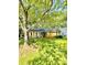 Charming home featuring a well-maintained yard, complemented by mature trees and quaint white shutters at 6832 Delta Lake Dr, Charlotte, NC 28215