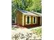 Charming home with yellow siding, white shutters, a walkway, and vibrant red landscaping at 6832 Delta Lake Dr, Charlotte, NC 28215