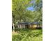 Charming home featuring a well-maintained yard, complemented by mature trees and quaint white shutters at 6832 Delta Lake Dr, Charlotte, NC 28215