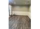 Spacious room with gray walls, white trim, and modern vinyl floors, ready for personalization at 6832 Delta Lake Dr, Charlotte, NC 28215