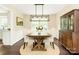 Bright dining room featuring a wooden table with modern lighting fixtures at 7020 Leesburg Rd, Charlotte, NC 28215