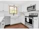 Bright kitchen with white cabinets, stainless steel appliances, and a farmhouse sink under a window at 7020 Leesburg Rd, Charlotte, NC 28215