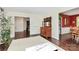 Open living room with hardwood floors, a white rug, and white French doors at 7020 Leesburg Rd, Charlotte, NC 28215