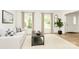 Bright living room featuring a white sofa, neutral-toned walls, and two windows at 7020 Leesburg Rd, Charlotte, NC 28215