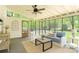 Inviting screened porch with vaulted ceiling, comfortable seating, and natural light at 7020 Leesburg Rd, Charlotte, NC 28215