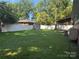 Expansive backyard with shed, lush lawn, covered patio, and privacy fence at 708 East St # 89, Albemarle, NC 28001