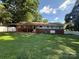 Large backyard with patio cover, fenced perimeter, and lush lawn at 708 East St # 89, Albemarle, NC 28001