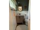 Cozy bathroom features wainscoting, decorative mirror and small wooden vanity at 708 East St # 89, Albemarle, NC 28001