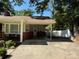 Charming home featuring a covered porch and carport with lush landscaping at 708 East St # 89, Albemarle, NC 28001