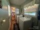 Bright laundry room features a side-by-side washer and dryer, and a doorway into the kitchen at 708 East St # 89, Albemarle, NC 28001