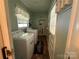 Practical laundry room equipped with washer, dryer, and storage shelves, ensuring convenience at 708 East St # 89, Albemarle, NC 28001
