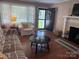 Comfortable living room with a fireplace, hardwood floors, and lots of natural light at 708 East St # 89, Albemarle, NC 28001