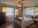 Primary bedroom featuring a four-poster bed, hardwood floors, and lots of natural light at 708 East St # 89, Albemarle, NC 28001