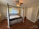 Cozy primary bedroom featuring a four-poster bed, hardwood floors, and a ceiling fan at 708 East St # 89, Albemarle, NC 28001