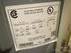 Close-up of the electric tank water heater label showing model number, serial number, and electrical ratings at 708 East St # 89, Albemarle, NC 28001